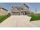 Charming two-story home with a three car garage, gray siding, brick accents and a concrete driveway at 4140 Omaha Dr, Bargersville, IN 46106