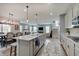 Open-concept living area shows kitchen island, dining table, living room, and staircase to the second floor at 4140 Omaha Dr, Bargersville, IN 46106