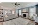 Open living room with a fireplace, ceiling fan, recessed lighting, and seamless access to the dining area at 4140 Omaha Dr, Bargersville, IN 46106