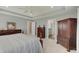 Inviting main bedroom with tray ceiling, neutral carpet, and classic dark wood furniture, exuding comfort at 4140 Omaha Dr, Bargersville, IN 46106
