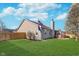 Backyard with flagpole, lush green grass, privacy fence and wood patio attached to the house at 4280 Zachary Ln, Westfield, IN 46062