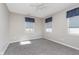 A bright, carpeted bedroom with two windows and neutral colored walls at 4280 Zachary Ln, Westfield, IN 46062