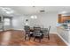 A dining room features wood flooring and a wooden dining table with seating for six at 4280 Zachary Ln, Westfield, IN 46062