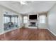 A living room with a fireplace features wood flooring and a ceiling fan at 4280 Zachary Ln, Westfield, IN 46062
