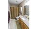 Well-lit bathroom featuring a vanity with solid surface countertops, tile flooring, and a shower-tub combo with patterned curtain at 498 Lake Shore Ct, Franklin, IN 46131