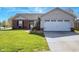 Charming single-story home with brick accents, a two-car garage, and a well-manicured lawn at 498 Lake Shore Ct, Franklin, IN 46131