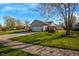 Charming single-story home with large front yard, mature trees, and a cozy porch swing on the side at 498 Lake Shore Ct, Franklin, IN 46131