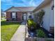 Inviting front porch with brick accents, decorative plants, and a welcoming entrance with glass storm door at 498 Lake Shore Ct, Franklin, IN 46131