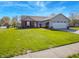 Well-maintained front yard with lush green grass and a charming brick and vinyl sided single story home at 498 Lake Shore Ct, Franklin, IN 46131