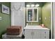 Well-lit bathroom featuring white vanity, neutral walls, framed mirror, and a decorative basket at 501 S John St, Arcadia, IN 46030