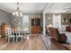 Open dining room with chandelier, hardwood floors, and a built-in china cabinet at 501 S John St, Arcadia, IN 46030