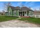 Charming green home featuring a well-maintained lawn and inviting front porch at 501 S John St, Arcadia, IN 46030