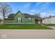 Charming green home featuring a well-maintained lawn and inviting front porch at 501 S John St, Arcadia, IN 46030