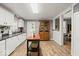 Bright kitchen features modern appliances, white cabinetry, and hardwood flooring at 501 S John St, Arcadia, IN 46030