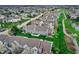 Picturesque aerial view featuring the backs of townhomes with patios, lush green spaces, and a walking path at 503 Fayette Dr, Westfield, IN 46074