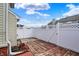 Backyard featuring a wooden patio, white fence and clear blue skies at 503 Fayette Dr, Westfield, IN 46074