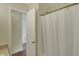 Bathroom featuring a shower with a white curtain, wood look floors and gold fixtures at 503 Fayette Dr, Westfield, IN 46074