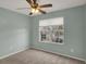 Well-lit bedroom with plush carpet, ceiling fan, and window overlooking the neighborhood at 503 Fayette Dr, Westfield, IN 46074
