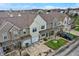 Eye-level view showcases townhomes, each with unique siding and attached garages, set in a meticulously maintained neighborhood at 503 Fayette Dr, Westfield, IN 46074