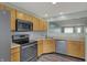Eat-in kitchen with wood cabinets, stainless steel appliances, and backsplash detail at 503 Fayette Dr, Westfield, IN 46074