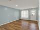 Open living room with wood floors, light blue walls, and natural light at 503 Fayette Dr, Westfield, IN 46074