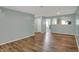 Open living room with wood floors, light blue walls, and view of kitchen at 503 Fayette Dr, Westfield, IN 46074