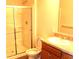Bathroom with shower, wood cabinets, toilet, and ample counter space at 5069 Lilium Dr, Plainfield, IN 46168