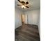Bedroom with hardwood floors, a ceiling fan, and multiple doors at 5069 Lilium Dr, Plainfield, IN 46168
