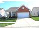 Charming single-Gathering home featuring a well-manicured lawn and attached two-car garage at 5069 Lilium Dr, Plainfield, IN 46168
