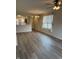Bright living room with a ceiling fan and a view of the kitchen at 5069 Lilium Dr, Plainfield, IN 46168