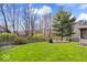 Large grassy backyard surrounded by a wood fence, mature trees, and landscaping perfect for outdoor activities and relaxation at 5343 Ripplingbrook Way, Carmel, IN 46033