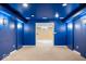 Home theater with blue walls and entrance to basement bar at 5343 Ripplingbrook Way, Carmel, IN 46033