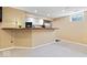 Basement wet bar including a stainless refrigerator, upper and lower cabinetry, and pendant lighting at 5343 Ripplingbrook Way, Carmel, IN 46033