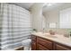 Bathroom with a shower featuring striped shower curtain, tile flooring, and wood vanity at 5343 Ripplingbrook Way, Carmel, IN 46033