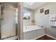 Bright bathroom featuring a soaking tub with a window, and a glass enclosed shower at 5343 Ripplingbrook Way, Carmel, IN 46033