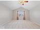 Empty bedroom with vaulted ceiling, ceiling fan, and large windows with curtains at 5343 Ripplingbrook Way, Carmel, IN 46033