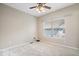 Cozy bedroom with neutral carpet, large window, and modern ceiling fan at 5343 Ripplingbrook Way, Carmel, IN 46033