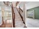 Welcoming two-story foyer featuring hardwood floors and an open staircase at 5343 Ripplingbrook Way, Carmel, IN 46033