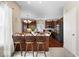 Bright kitchen showcasing a central island with seating, hardwood cabinets and floors, and modern lighting at 5343 Ripplingbrook Way, Carmel, IN 46033