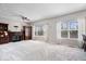 Spacious living room with large windows, a fireplace, and built in bookshelves at 5343 Ripplingbrook Way, Carmel, IN 46033
