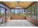 Relaxing screened porch with wood ceiling, wood trim and view of trees in the backyard at 5343 Ripplingbrook Way, Carmel, IN 46033