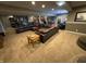 Expansive finished basement with carpeting and dark leather seating area at 5373 Ashby Ct, Greenwood, IN 46143