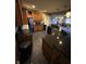The kitchen includes dark granite countertops, dark cabinetry, and tile floors at 5373 Ashby Ct, Greenwood, IN 46143