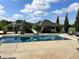Backyard pool with slide, surrounded by lush landscaping and a covered outdoor lounge area, perfect for relaxation at 5373 Ashby Ct, Greenwood, IN 46143