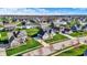 An attractive neighborhood is captured from above, highlighting mature trees and manicured lawns at 5492 Cottage Grove Ln, Noblesville, IN 46062
