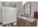 Charming full bathroom with granite countertop, wood cabinets, a framed mirror, and a shower/tub combination at 5492 Cottage Grove Ln, Noblesville, IN 46062