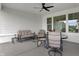 Relaxing covered patio featuring comfortable seating, a ceiling fan, and view of the backyard at 5492 Cottage Grove Ln, Noblesville, IN 46062