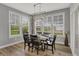 The dining room has a modern light fixture and large windows at 5492 Cottage Grove Ln, Noblesville, IN 46062
