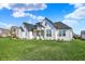 Beautiful home with black roof accents, crisp white siding, a manicured lawn, and beautiful landscaping at 5492 Cottage Grove Ln, Noblesville, IN 46062