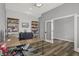 Home office featuring wood floors, gray walls, a modern desk, and custom shelving at 5492 Cottage Grove Ln, Noblesville, IN 46062